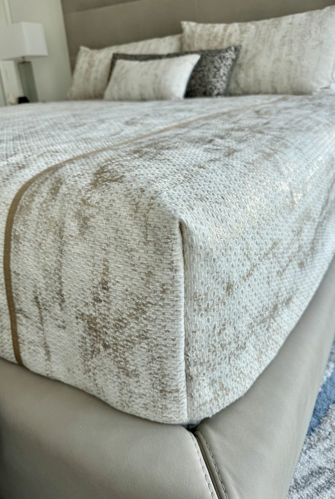 A close up the tailored corner of a bed cap made to fit the bed exactly